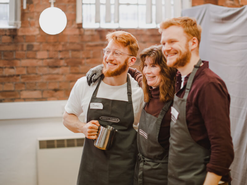 A mother and her two sons at a candle making class